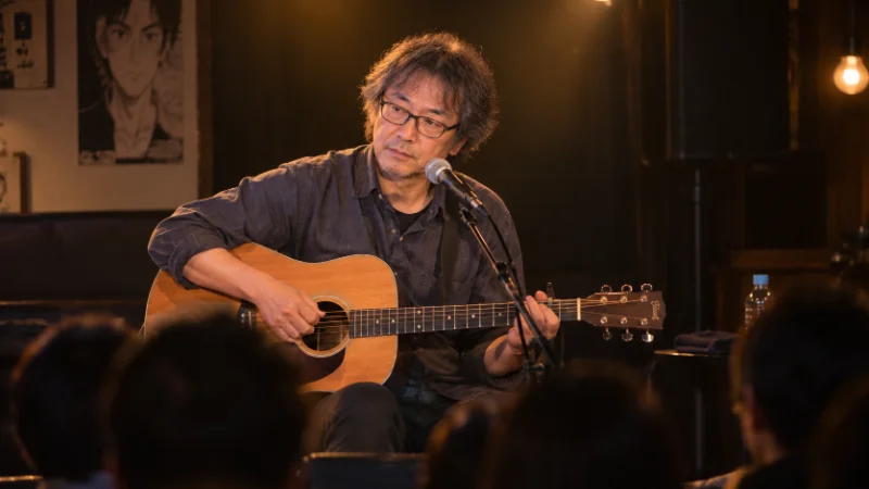 Naoki Urasawa performing music on stage