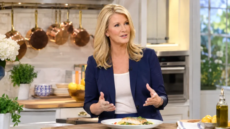 Sandra Lee smiling in a television kitchen studio during a cooking segment